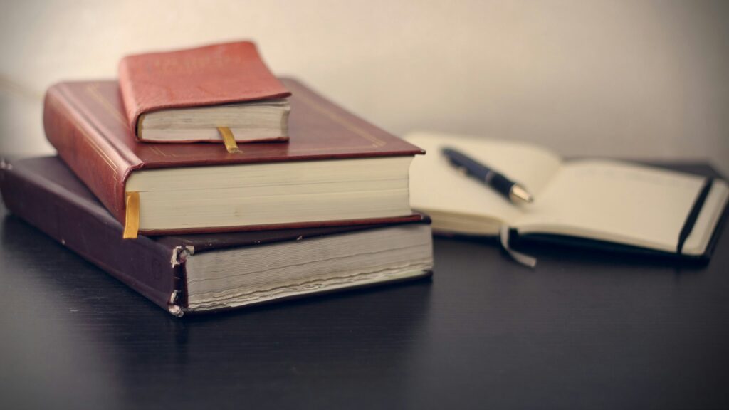 Stack of legal books on a wooden shelf.